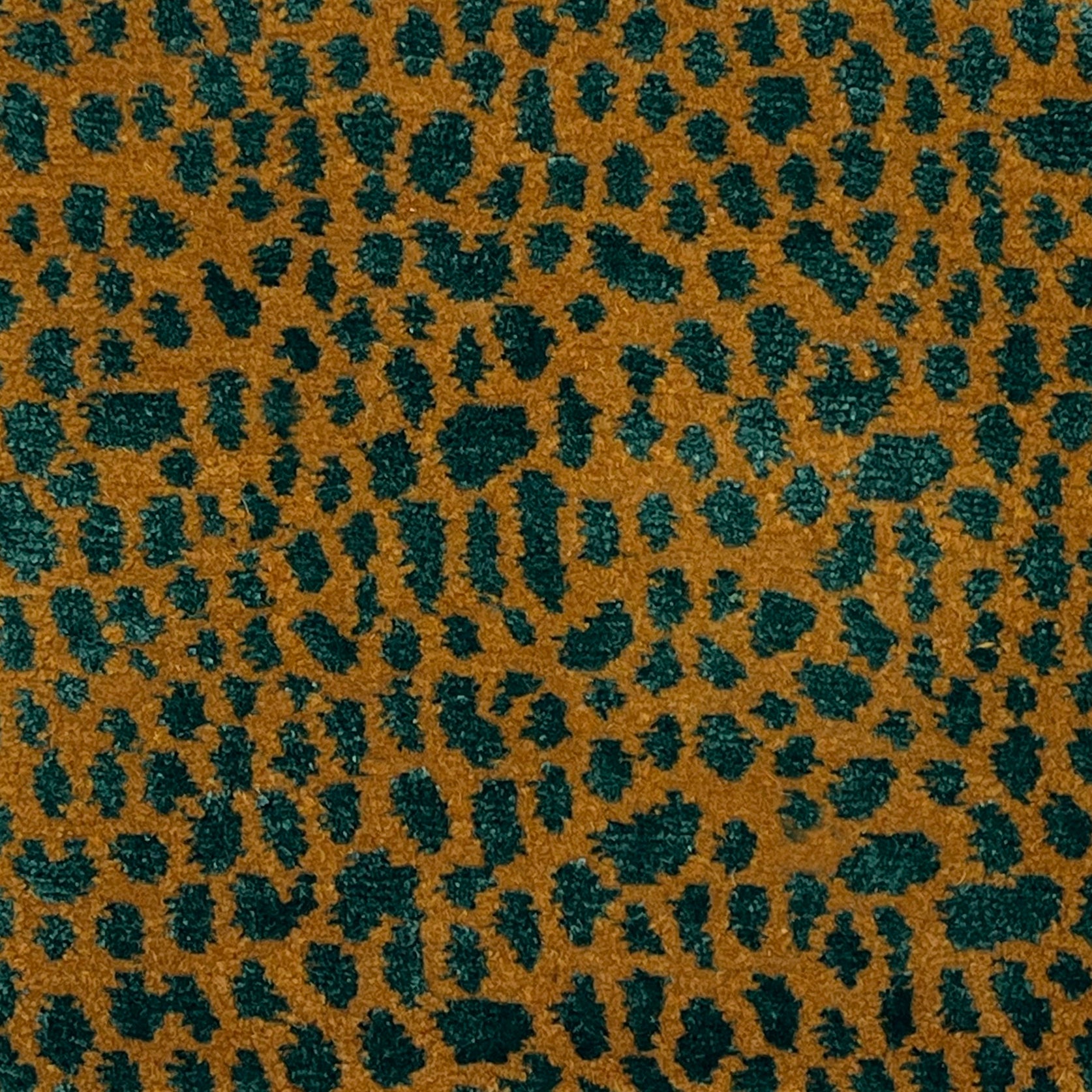 Handknotted rug with animal skin motif in orange and green. 