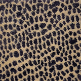 Handknotted rug with animal skin motif in purple on cream. 