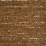 A close-up of a brown handknotted carpet with horizontal brushed lines 
