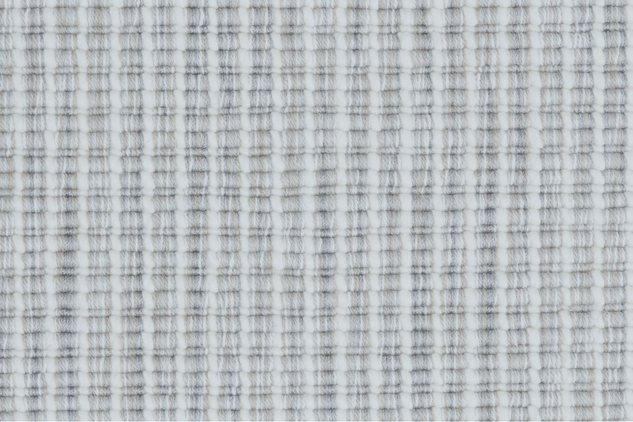 Broadloom carpet in a ribbed striated stripe in shades of cream and cool grey.