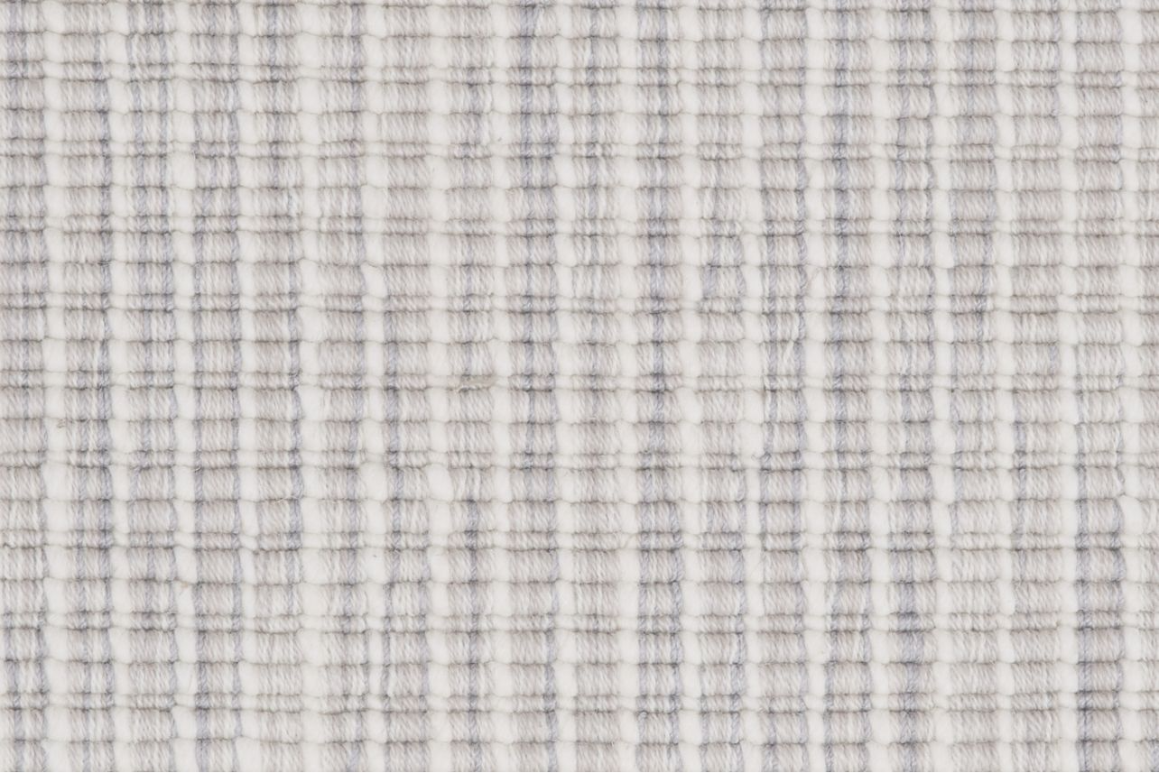 Broadloom carpet in a ribbed striated stripe in shades of cream, grey and beige.