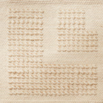 Flatwoven rug with a raised border corner design in cream.
