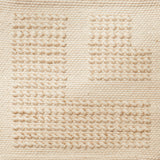 Flatwoven rug with a raised border corner design in cream.
