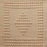 Flatwoven rug with a raised border and diamond design in tan and cream.