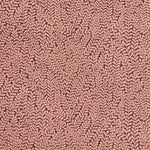Detail of fabric in a scrolling stem and leaf print in coral on a maroon field.