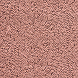 Detail of fabric in a scrolling stem and leaf print in coral on a maroon field.