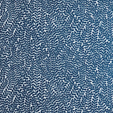 Detail of wallpaper in a scrolling stem and leaf print in navy on a white field.
