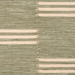 Broadloom flatweave carpet in a broken stripe in white on a sage green field.