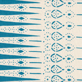 Detail of fabric in a bordered teardrop print in turquoise on a cream field.