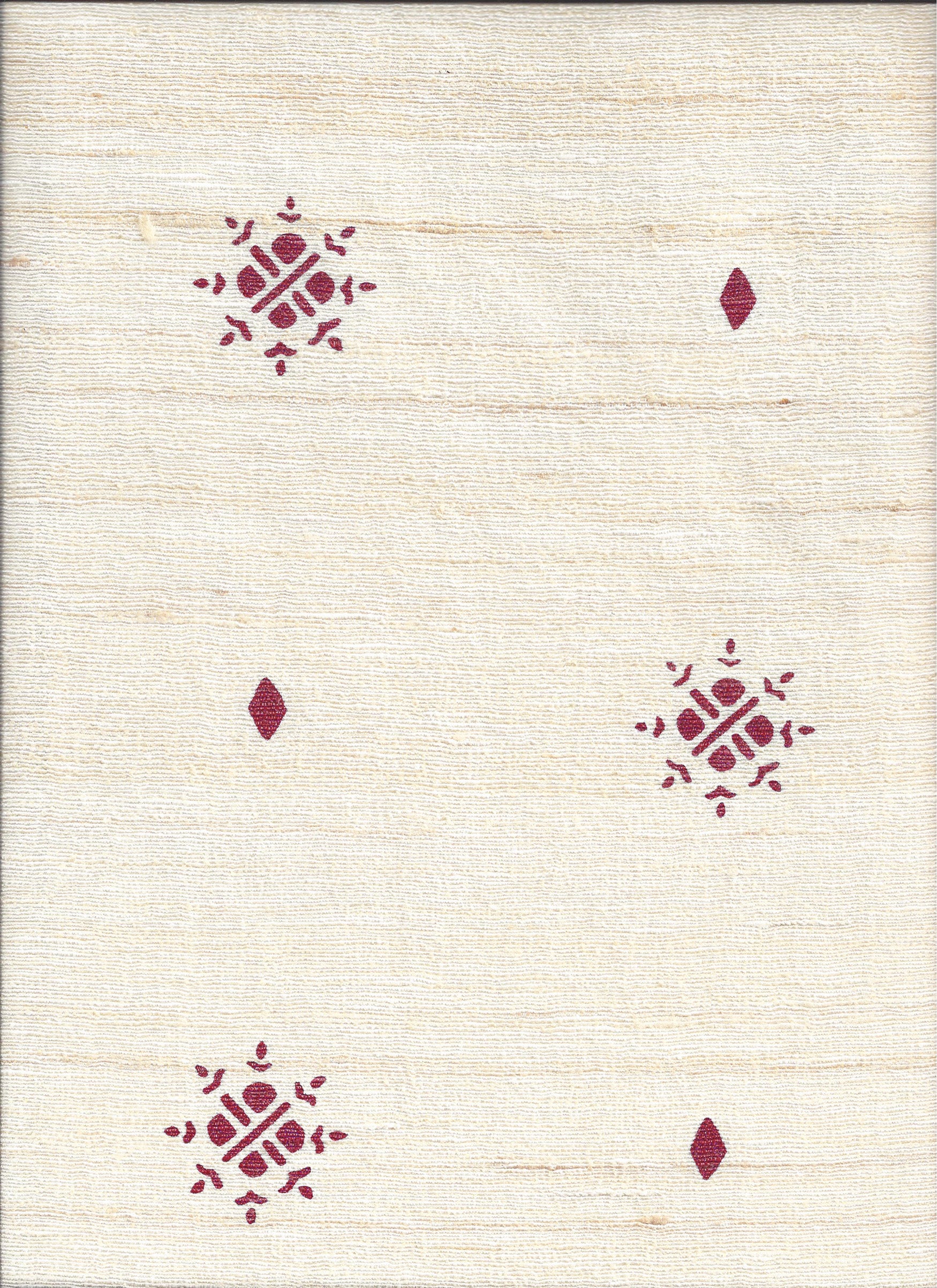 Detail of fabric in a repeating geometric starburst print in red on a cream field.