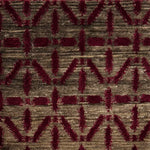 Handknotted rug with magenta linear design on a heather brown field. 