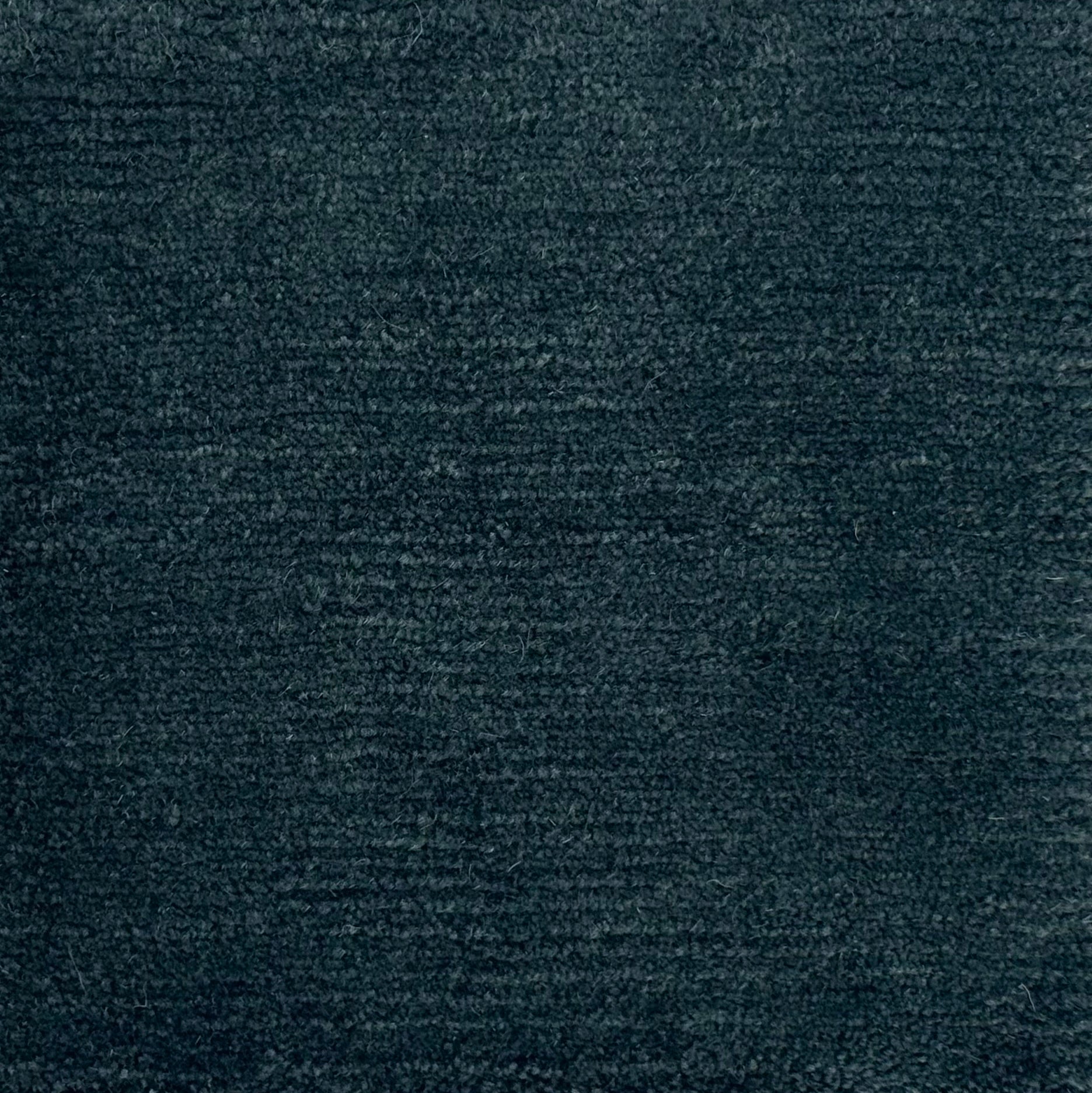 Handknotted rug in wool and merino in solid cut pile in dark teal blue.