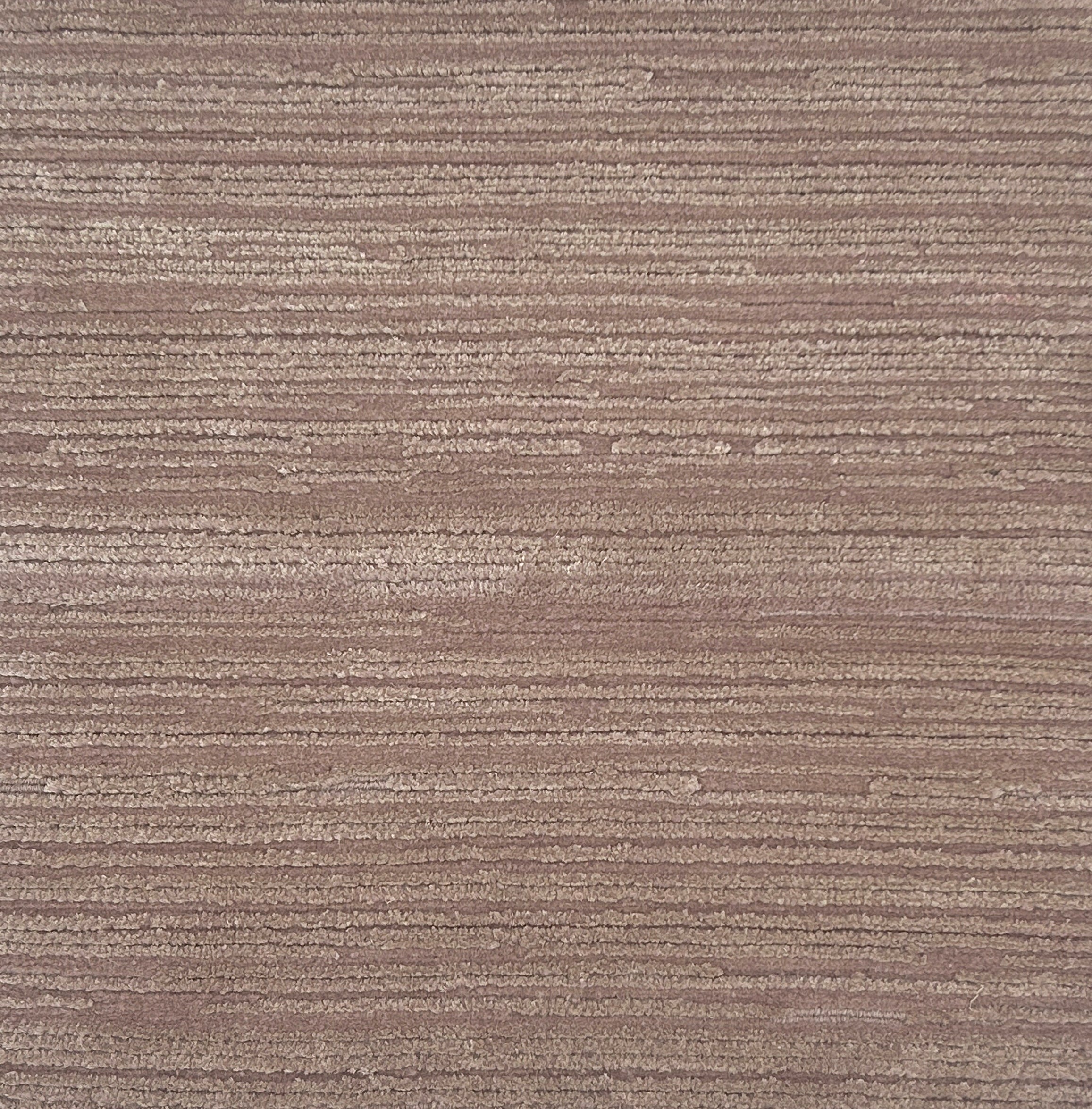 Handknotted rug in a textrural rib in light purple. 