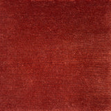 Handknotted cut pile rug in rust red.