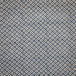 Detail of fabric in a diamond lattice print in navy on a cream field.