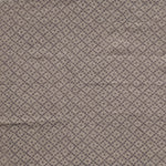 Detail of fabric in a diamond lattice print in gray on a greige field.