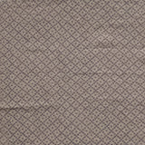 Detail of fabric in a diamond lattice print in gray on a greige field.