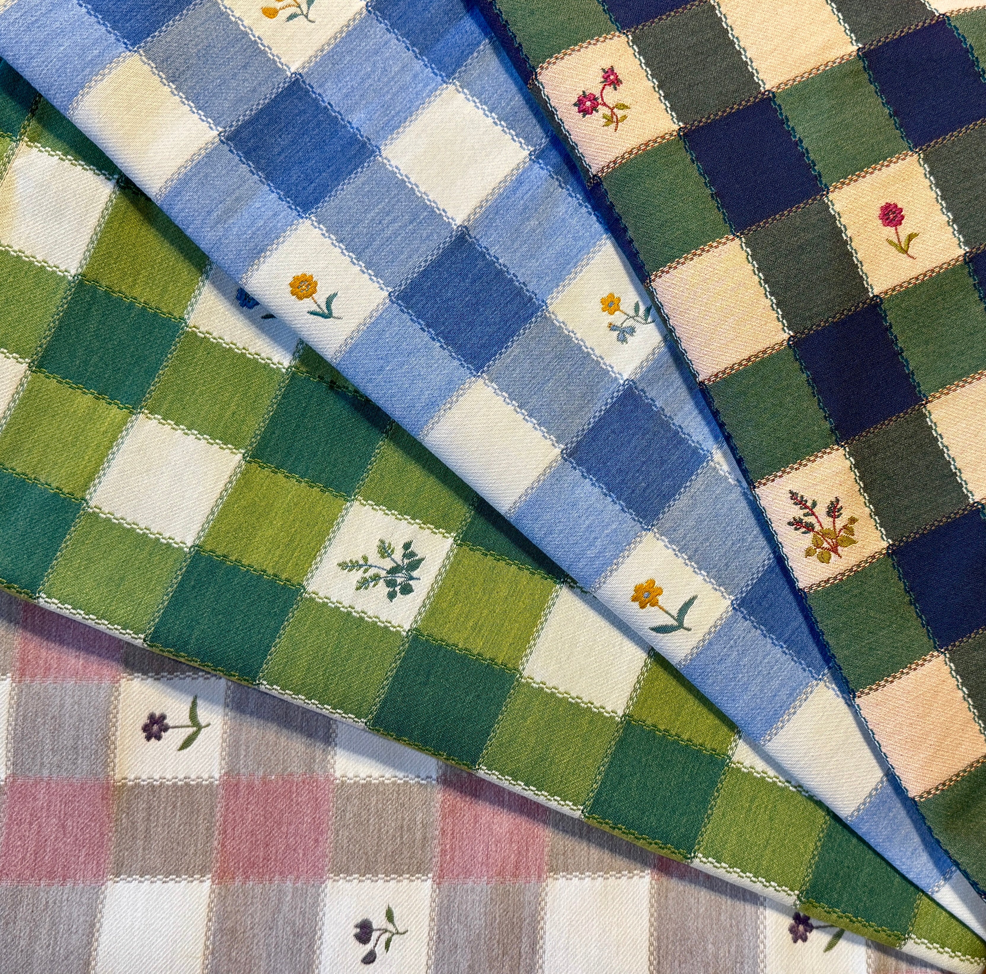 Close-up of checkered fabric with  flowers in various colors.