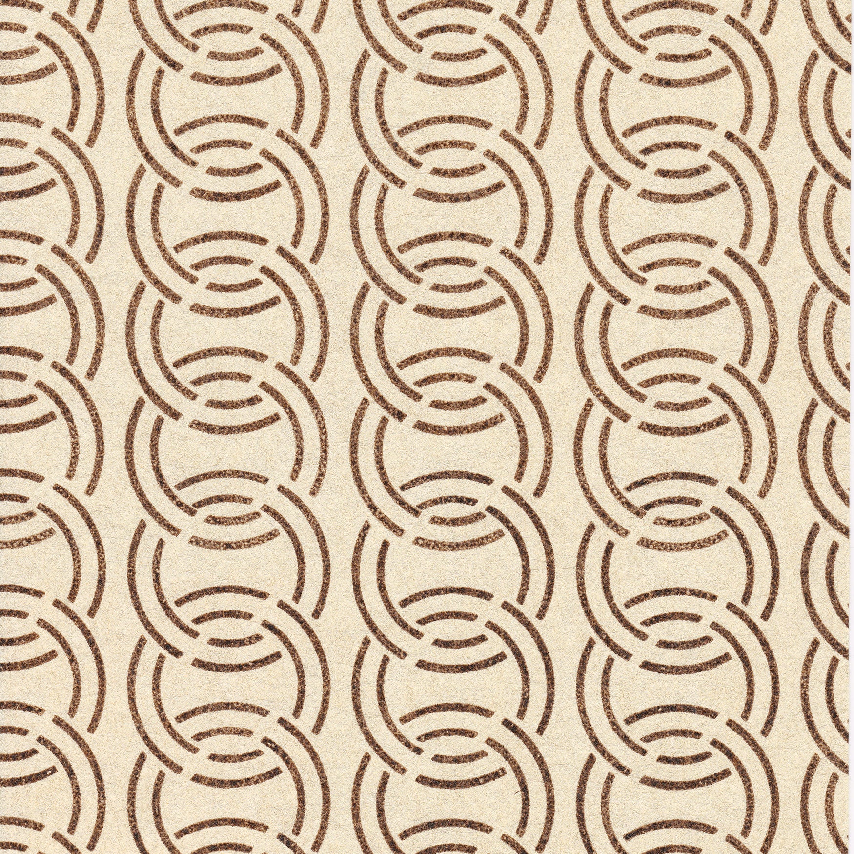Detail of wallpaper in an interlocking circular pattern in mottled brown on a cream field.
