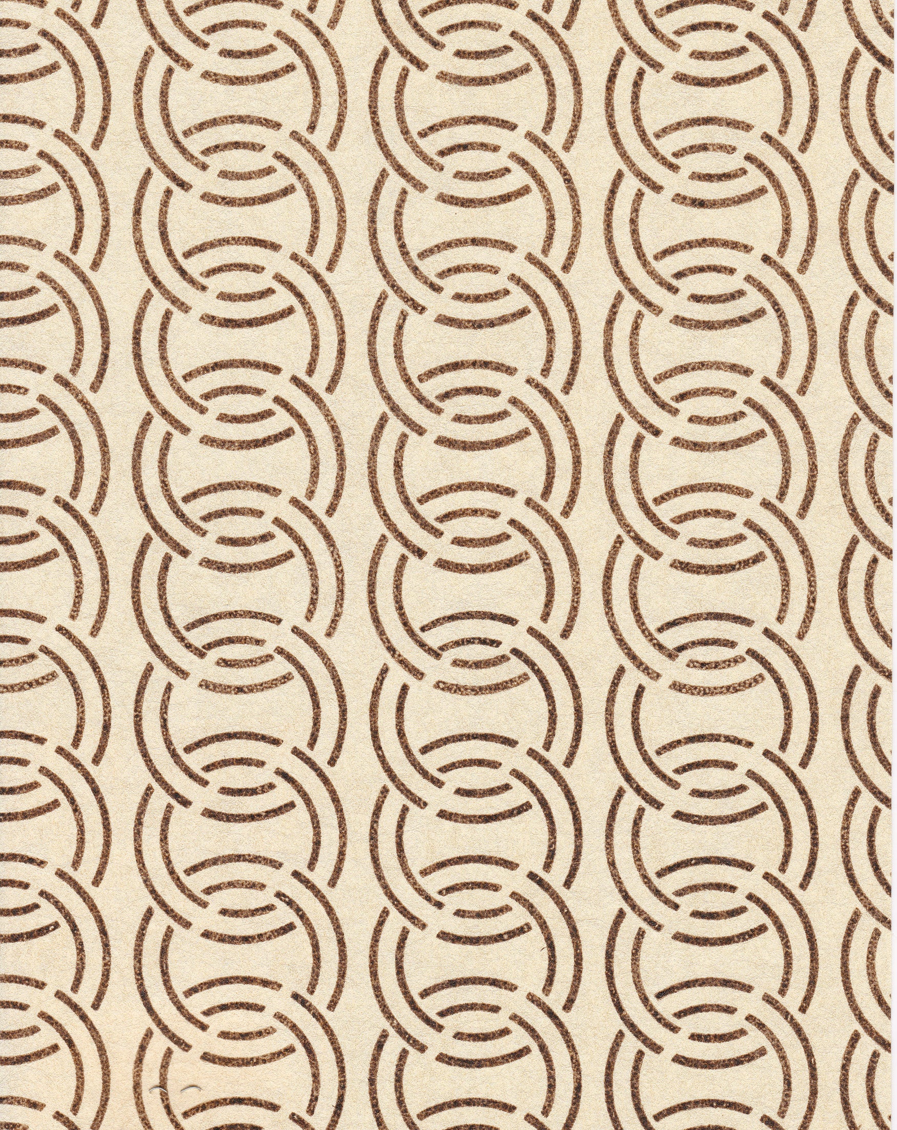 Detail of wallpaper in an interlocking circular pattern in mottled brown on a cream field.
