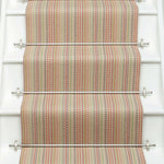 Striped flatweave runner in red green blue orange on white staircase
