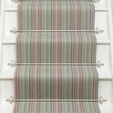 Striped flatweave runner in green pink blue red on white staircase