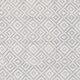Detail of fabric in a geometric diamond print in gray on a cream field.