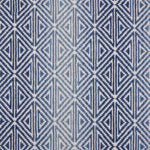 Broadloom carpet with triangle pattern with an ombré background in shades of blue. 