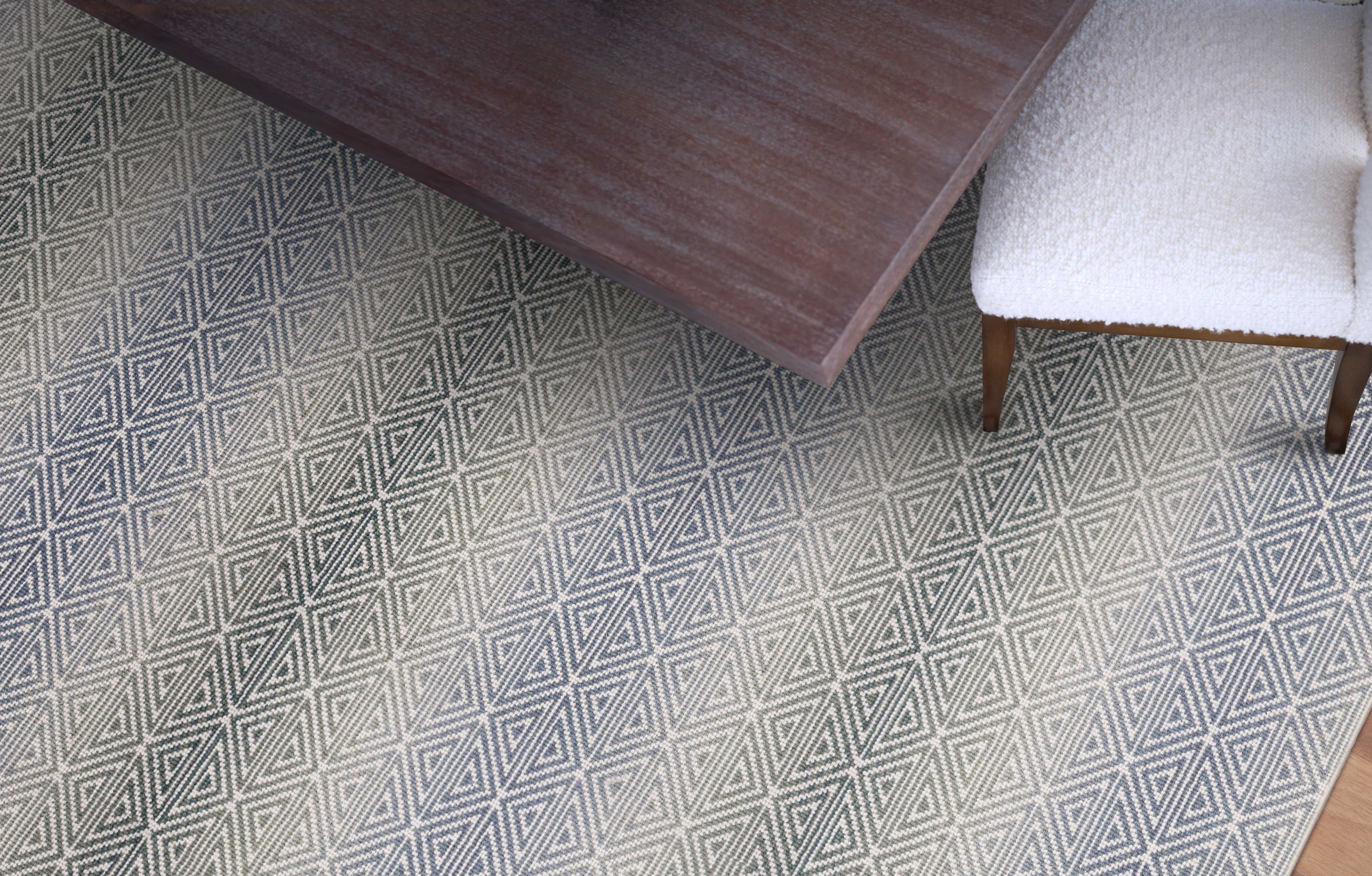 Patterned rug with a wooden table and chair on a geometrically designed floor.