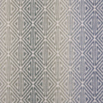 Broadloom carpet with triangle pattern with an ombré background in blue and green. 