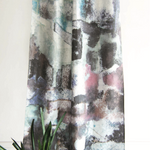 Abstract patterned curtain with a plant in the foreground