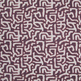 Fabric in an abstract meandering shape print in white and pink on a maroon field.