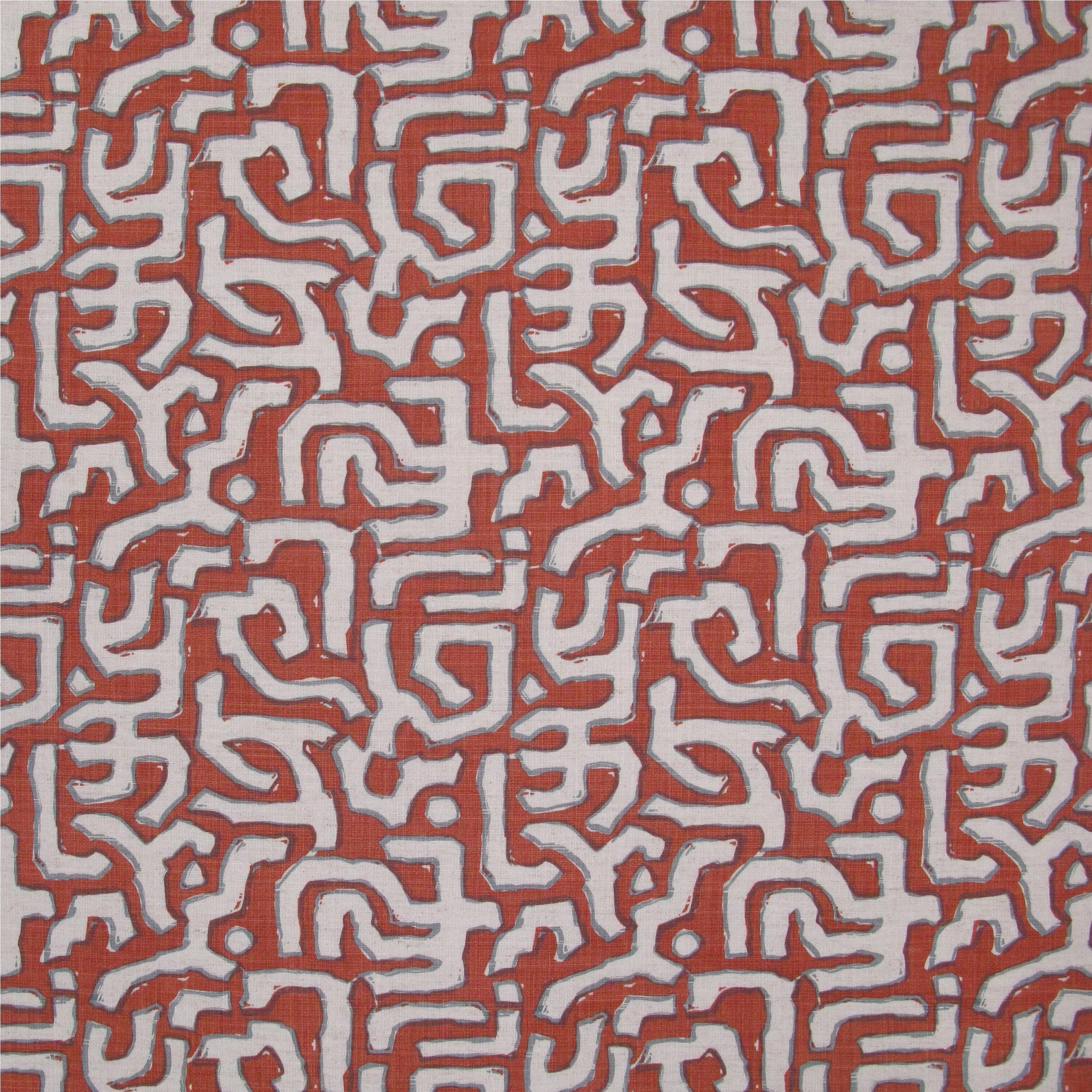 Fabric in an abstract meandering shape print in white and gray on a red field.