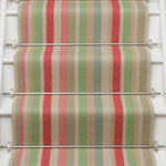 Striped flatweave runner in green pink blue red yellow on white staircase