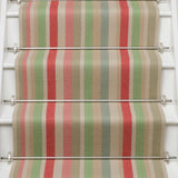 Striped flatweave runner in green pink blue red yellow on white staircase