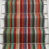 Striped flatweave runner in green blue purple orange red on white staircase