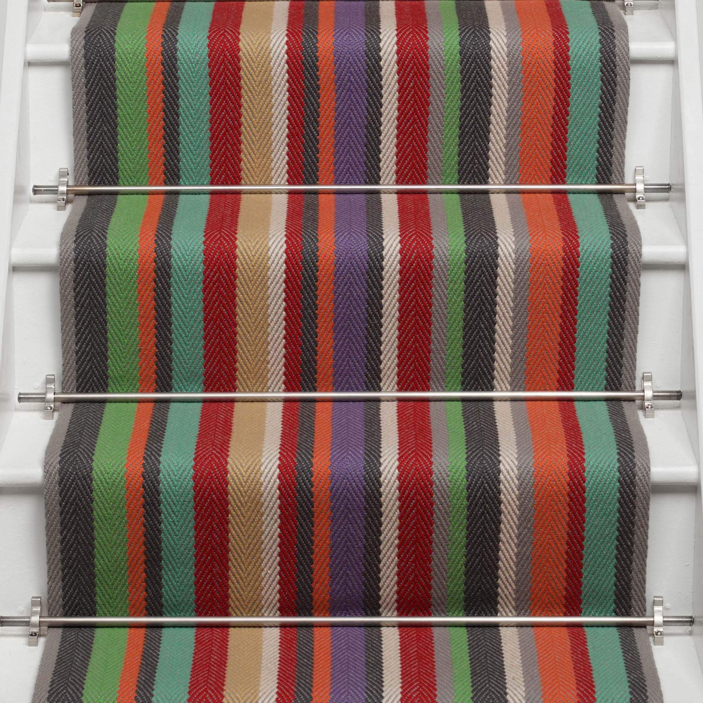 Striped flatweave runner in green blue purple orange red on white staircase