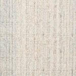 Broadloom carpet in a textural strie in cream accented with pastel blue and tan.