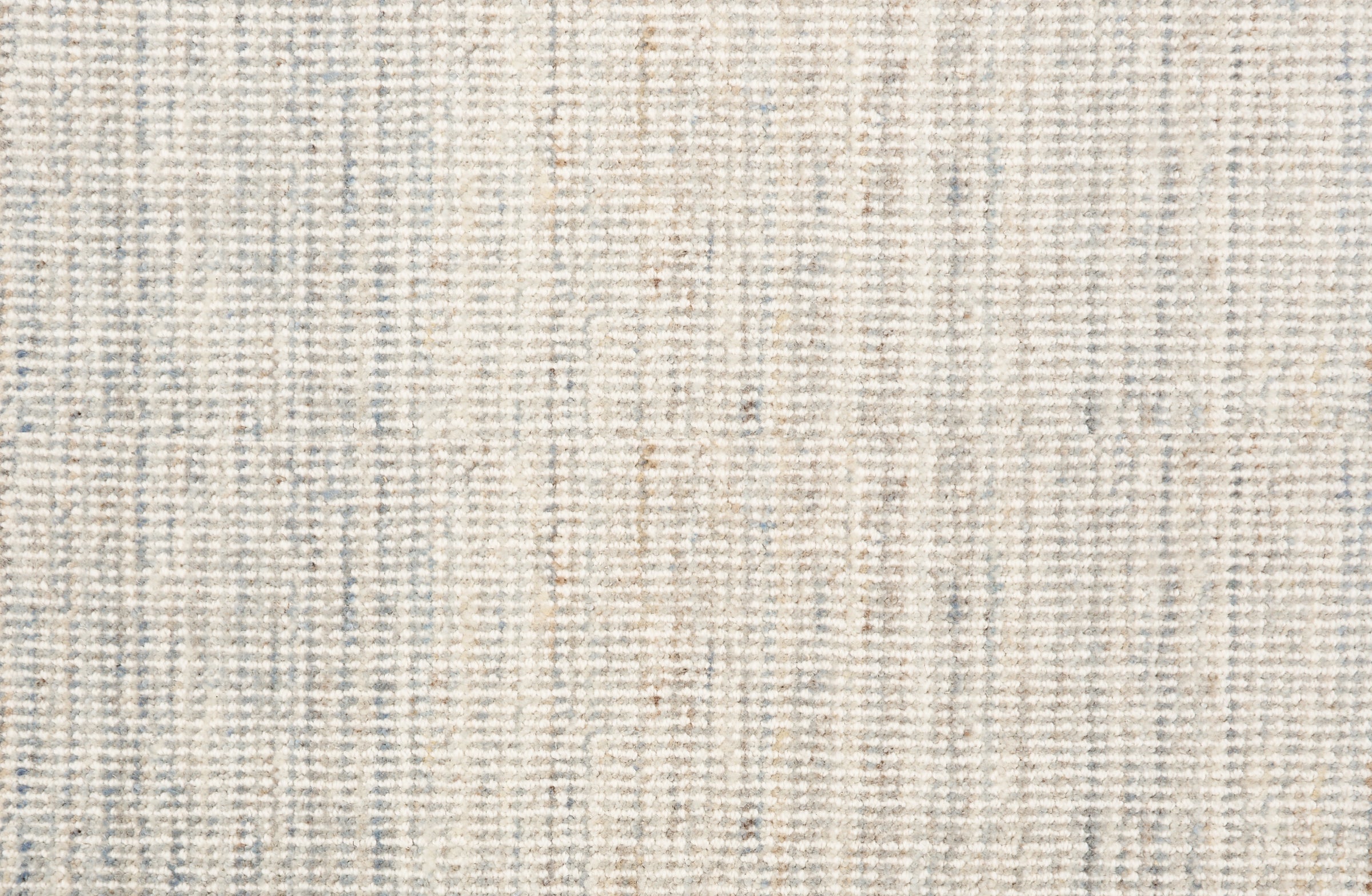 Broadloom carpet in a textural strie in cream accented with pastel blue and tan.