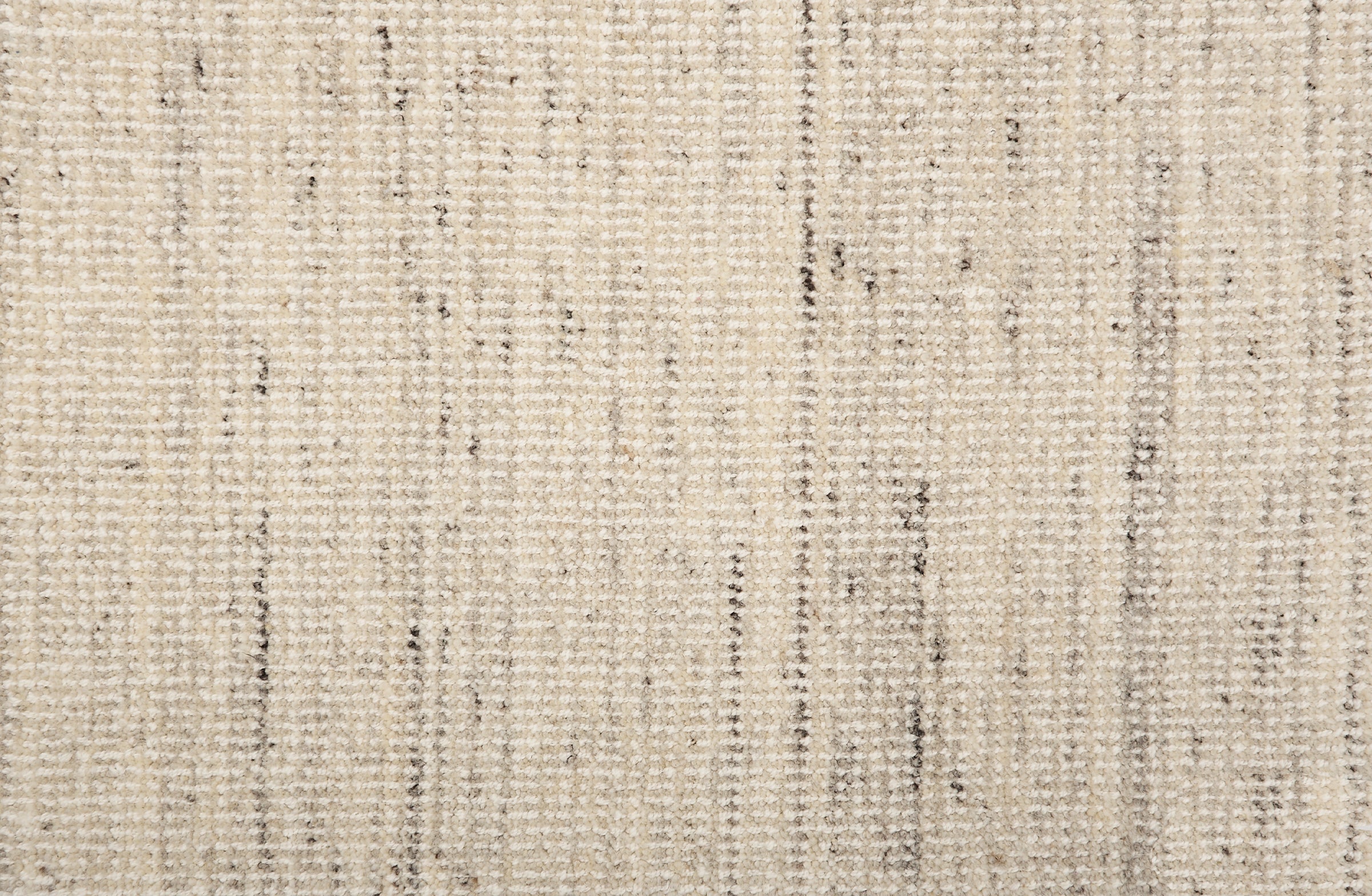 Broadloom carpet in a textural strie in cream accented with dark and light grey.