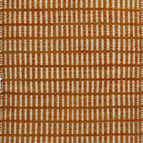 Textured rug with an orange and beige  checker pattern