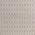 Handwoven wool rug with an oval and diamond lattice pattern in shades of cream and beige. 