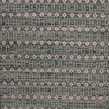 Handwoven wool rug with an oval and diamond lattice pattern in shades of green and brown with pink accents. 