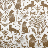 Wallpaper in a lion and plant print in brown on a white field.