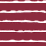 Detail of fabric in a wide undulating stripe pattern in pink and white on a mulberry field.