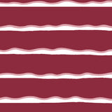 Detail of fabric in a wide undulating stripe pattern in pink and white on a mulberry field.