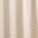 Draped fabric yardage in a mottled lattice print in white on a cream field.