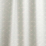 Draped fabric yardage in a mottled lattice print in white on a light blue field.