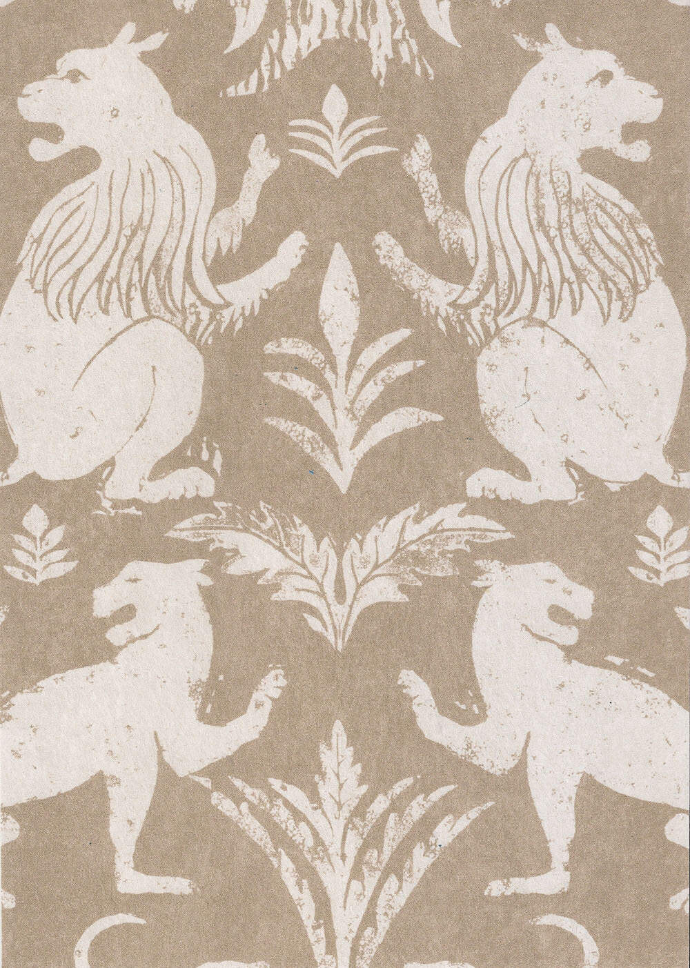 Close-up of wallpaper in a lion and plant print in white on a mottled cream field.