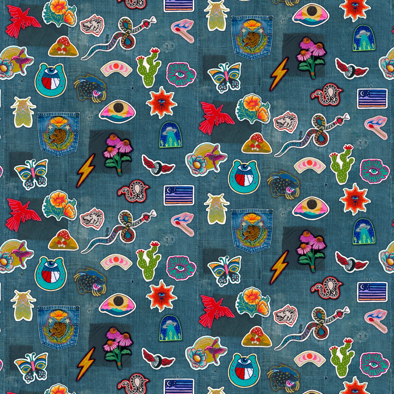 Collection of colorful embroidered patches on a denim fabric background
